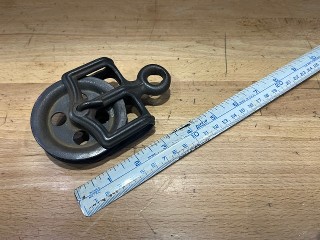 Small antique steel pulley with 3-inch sheave