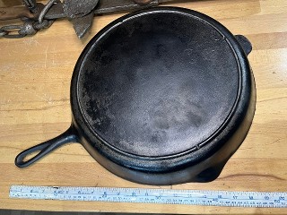 Antique Lodge No. 14 US, 3 notch, heat ring, cast iron skillet, 15-inch diameter by 2 1/2-inches tall, weighs about 10 lbs. Antique Lodge No. 14 US, 3 notch, heat ring, cast iron skillet, 15-inch diameter by 2 1/2-inches tall, weighs about 10 lbs.