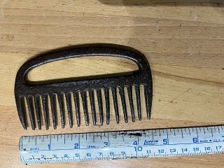 Antique cast iron horse comb, measures 4 3/4 x 2 3/4