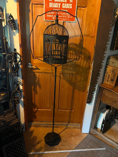 Antique bird cage with cast iron stand, it measures about 20 x 63 tall. Antique bird cage with cast iron stand, it measures about 20 x 63 tall.