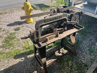 Antique power hacksaw with cast iron legs, with vice, very heavy, needs a motor. Antique power hacksaw with cast iron legs, with vice, very heavy, needs a motor.
